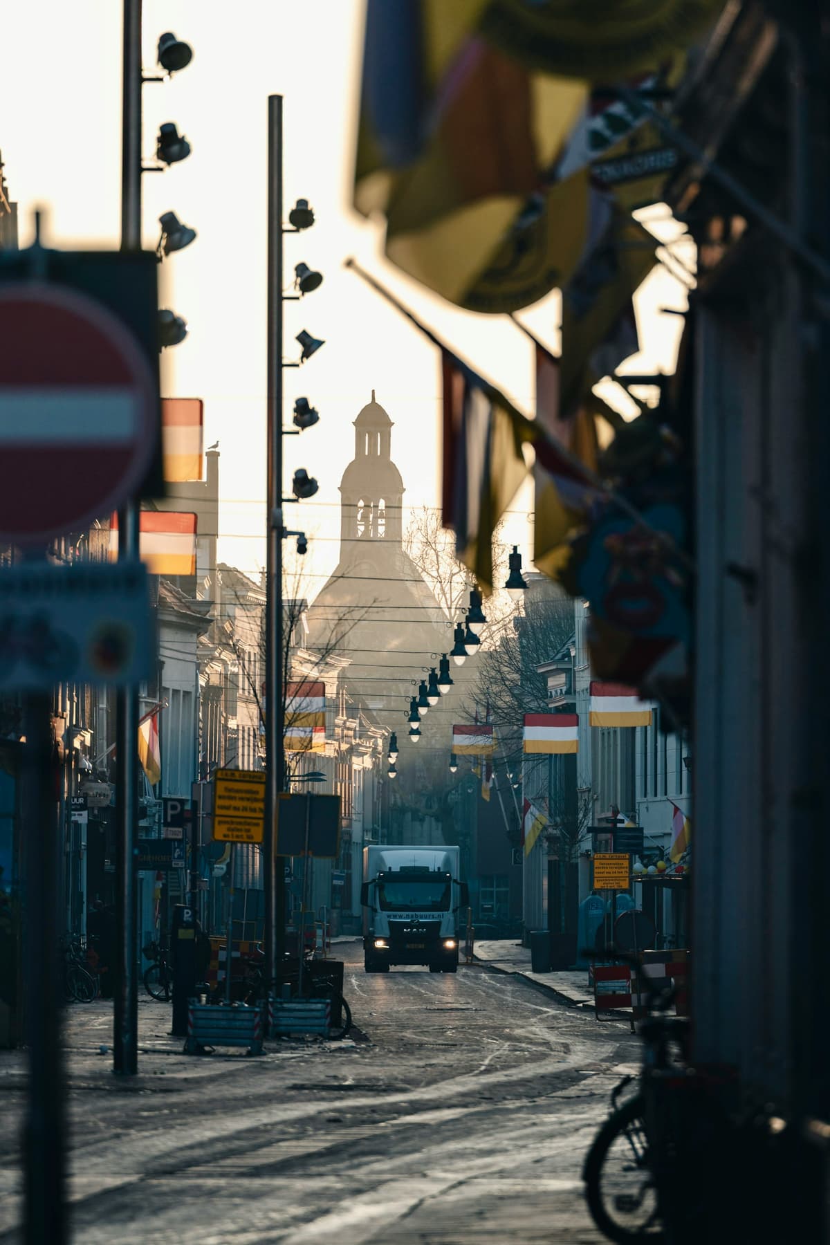 Ochtendlicht in een winkelstraat in Den Bosch, met de Sint-Janstoren in de verte